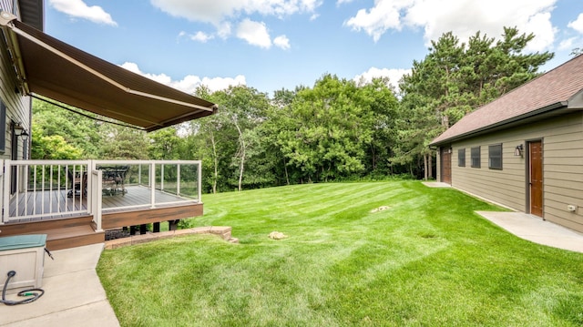 3946 Woodcrest Ct, Eau Claire, WI 54701 - view of grassy yard featuring a wooden deck and view of scattered trees