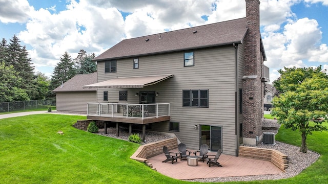 3946 Woodcrest Ct, Eau Claire, WI 54701 - rear view of property featuring a chimney, a fire pit, a wooden deck, and a patio area