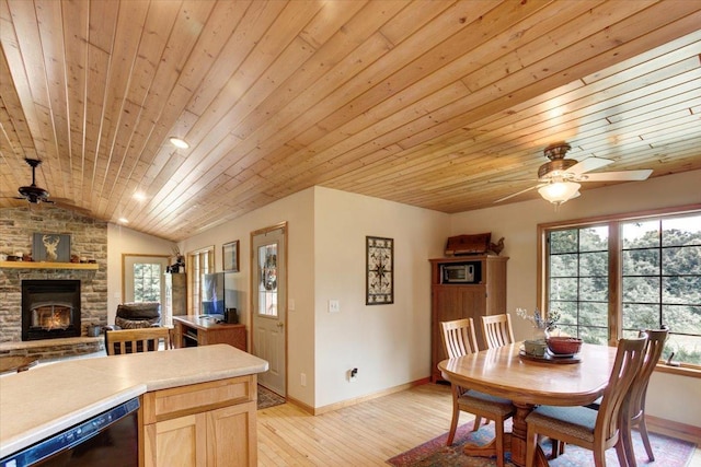 N12943 600th St, Wilson, WI 54772 - dining room featuring wood ceiling, a fireplace, vaulted ceiling, a ceiling fan, and healthy amount of natural light