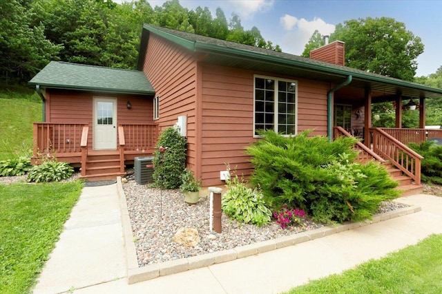 N12943 600th St, Wilson, WI 54772 - view of front of home with a chimney, a deck, and stairway
