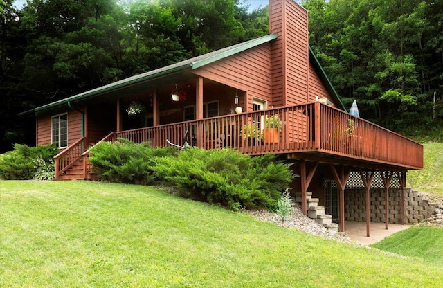 N12943 600th St, Wilson, WI 54772 - back of property with a chimney, a lawn, and a wooden deck