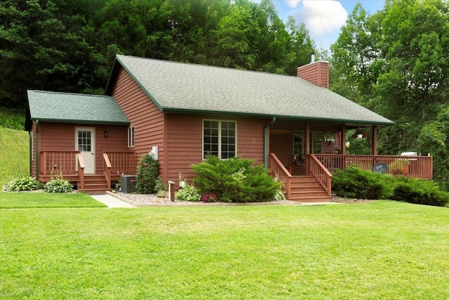 N12943 600th St, Wilson, WI 54772 - view of front of home with a chimney, a front lawn, a porch, and a shingled roof