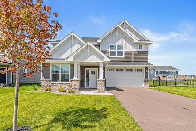 11374 81st St NE, Otsego, MN 55330 - craftsman-style house with board and batten siding, stone siding, an attached garage, asphalt driveway, and a shingled roof