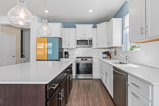 11374 81st St NE, Otsego, MN 55330 - kitchen featuring appliances with stainless steel finishes, light countertops, white cabinetry, tasteful backsplash, and recessed lighting