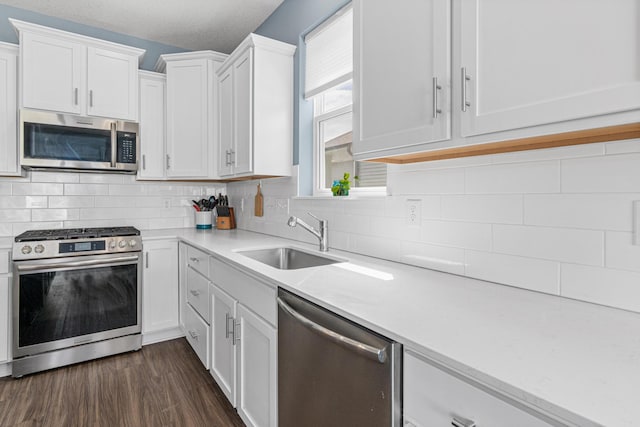 11374 81st St NE, Otsego, MN 55330 - kitchen featuring appliances with stainless steel finishes, light countertops, white cabinets, and dark wood-type flooring