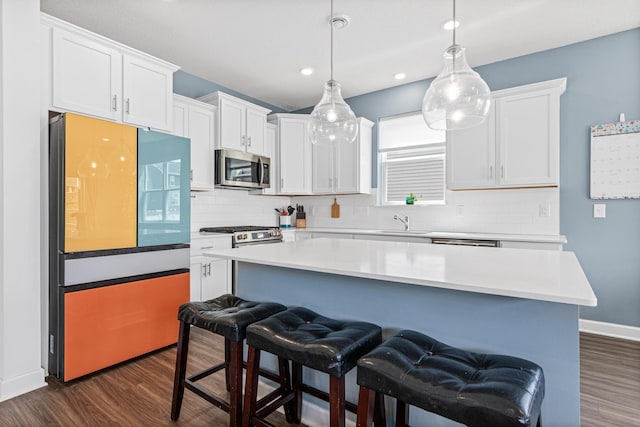11374 81st St NE, Otsego, MN 55330 - kitchen featuring stainless steel microwave, refrigerator, dark wood-style flooring, backsplash, and recessed lighting