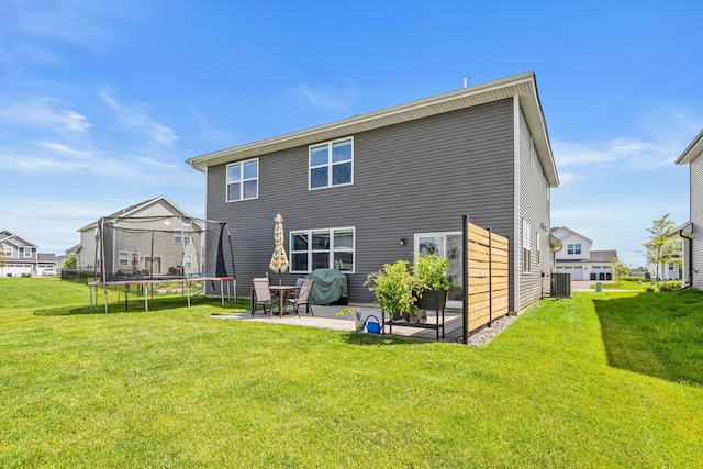 11374 81st St NE, Otsego, MN 55330 - rear view of property with a trampoline, a patio area, and a lawn