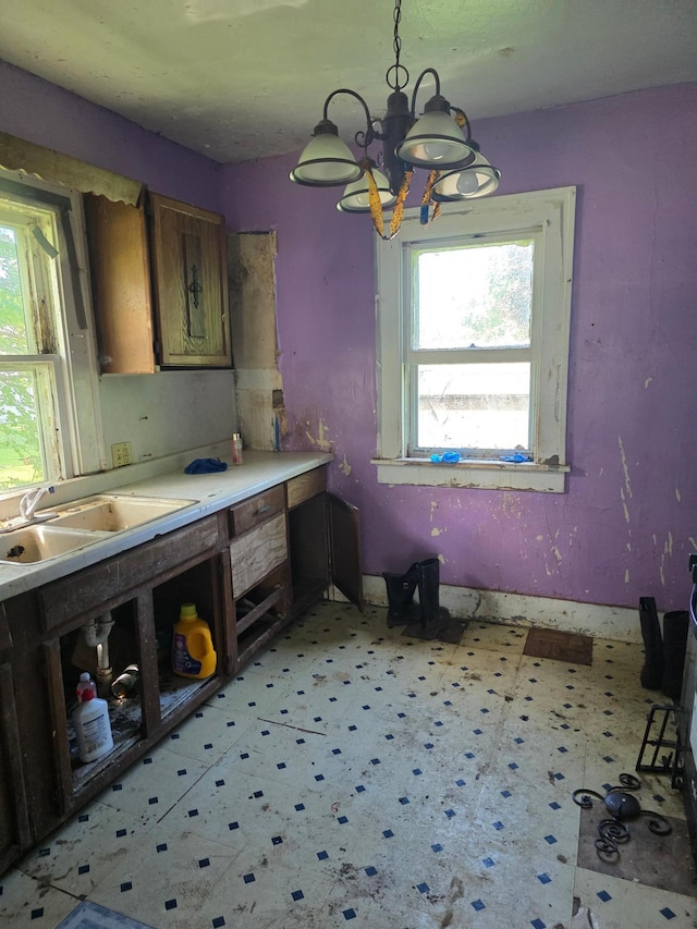 1637 Miller St, Worthington, MN 56187 - kitchen with light floors, a chandelier, brown cabinetry, and decorative light fixtures