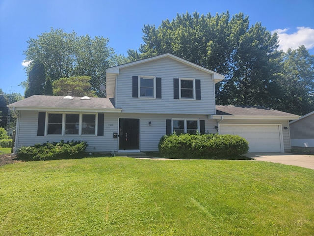 9225 Northwood Pkwy, New Hope, MN 55427 - tri-level home featuring a garage, a front lawn, and concrete driveway