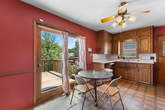 4251 Quincy St NE, Columbia Heights, MN 55421 - kitchen featuring light countertops, light flooring, brown cabinets, a ceiling fan, and dishwasher