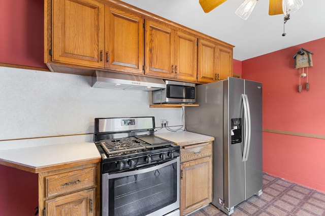 4251 Quincy St NE, Columbia Heights, MN 55421 - kitchen featuring appliances with stainless steel finishes, light countertops, under cabinet range hood, light floors, and brown cabinets