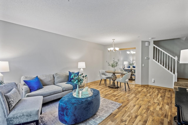 8484 Minuteman Alcove, Eden Prairie, MN 55344 - living area featuring a chandelier, light wood-style floors, stairs, and a textured ceiling