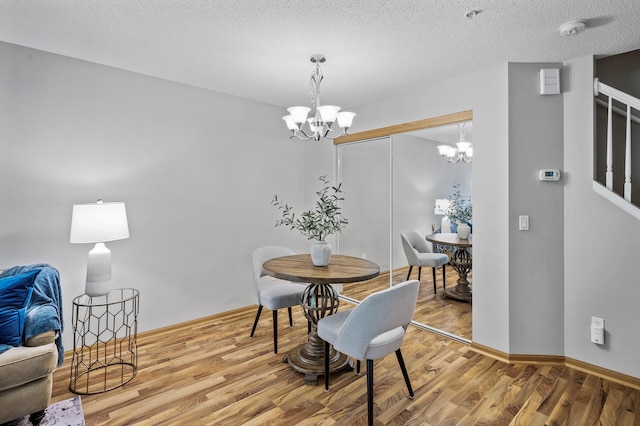 8484 Minuteman Alcove, Eden Prairie, MN 55344 - dining area with a chandelier, wood finished floors, stairs, and a textured ceiling