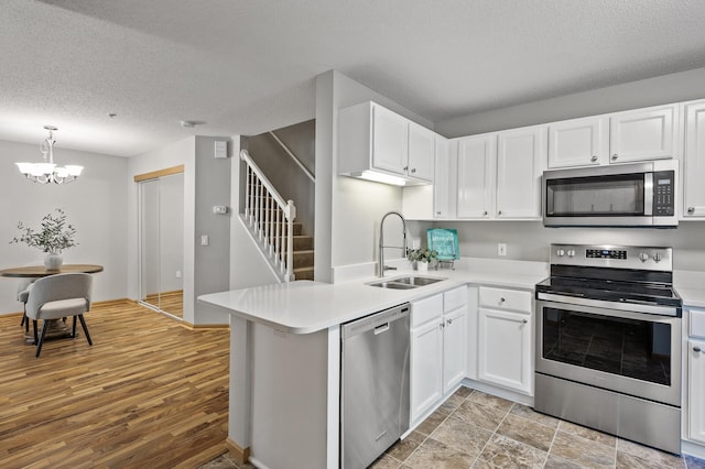 8484 Minuteman Alcove, Eden Prairie, MN 55344 - kitchen with appliances with stainless steel finishes, white cabinets, light countertops, a chandelier, and a textured ceiling