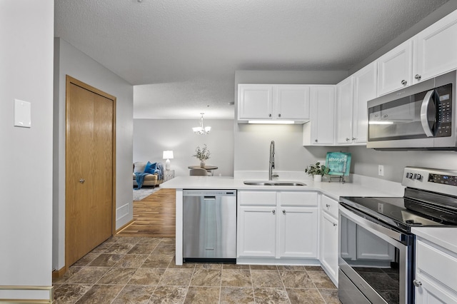 8484 Minuteman Alcove, Eden Prairie, MN 55344 - kitchen with stainless steel appliances, light countertops, a chandelier, white cabinetry, and a textured ceiling
