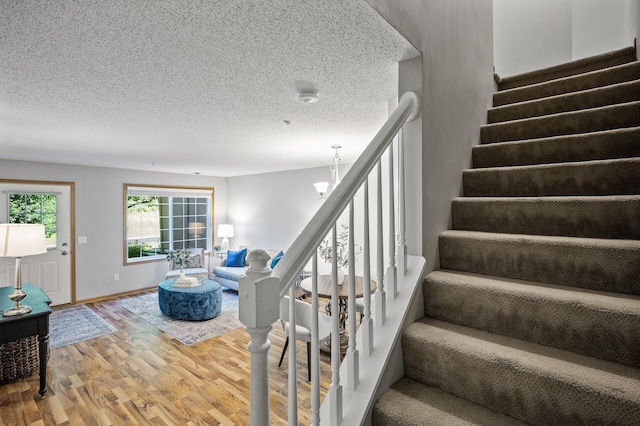 8484 Minuteman Alcove, Eden Prairie, MN 55344 - stairway with wood finished floors and a textured ceiling