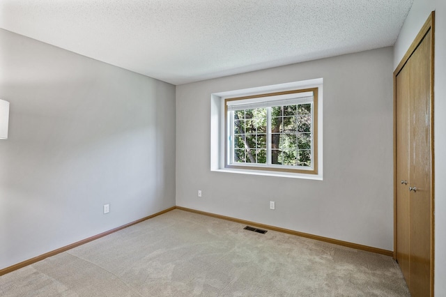 8484 Minuteman Alcove, Eden Prairie, MN 55344 - unfurnished bedroom featuring light carpet, a textured ceiling, and a closet