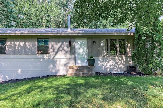 15106 Zuni St NW, Ramsey, MN 55303 - ranch-style home with a front lawn, a shingled roof, and board and batten siding