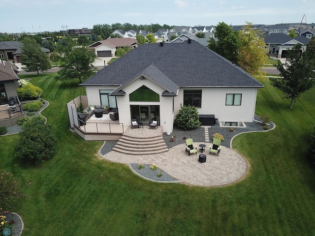 4703 Woodhaven St S, Fargo, ND 58104 - rear view of house featuring roof with shingles, a wooden deck, outdoor lounge area, a patio area, and a lawn