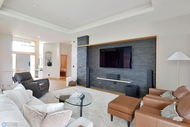 4703 Woodhaven St S, Fargo, ND 58104 - living room featuring a tray ceiling and light wood-style floors