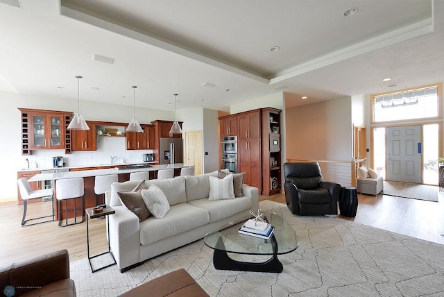 4703 Woodhaven St S, Fargo, ND 58104 - living area with light wood finished floors, recessed lighting, and a raised ceiling