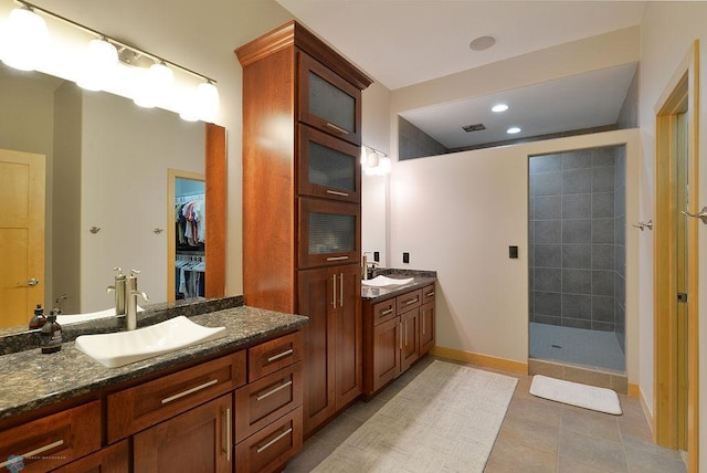 4703 Woodhaven St S, Fargo, ND 58104 - bathroom with vanity, walk in shower, tile patterned flooring, a walk in closet, and recessed lighting