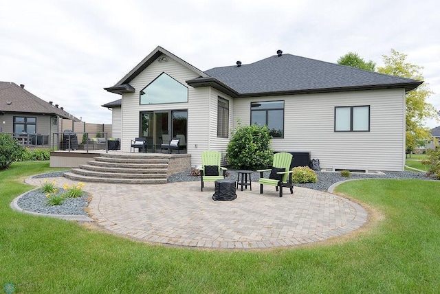 4703 Woodhaven St S, Fargo, ND 58104 - rear view of property featuring a yard, a patio area, a wooden deck, and a shingled roof