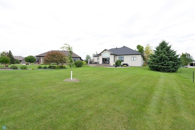 4703 Woodhaven St S, Fargo, ND 58104 - view of green lawn with a patio area