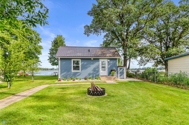 27096 Little Floyd Lake Rd Unit 8, Detroit Twp, MN 56501 - rear view of house with a metal roof, a water view, and a fire pit
