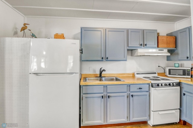 27096 Little Floyd Lake Rd Unit 8, Detroit Twp, MN 56501 - kitchen featuring white appliances, under cabinet range hood, light countertops, and gray cabinets