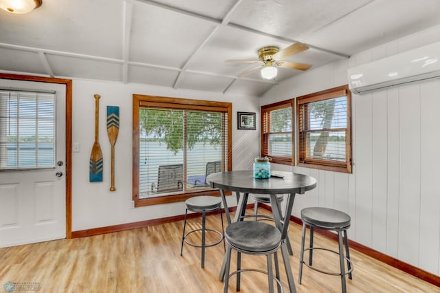 27096 Little Floyd Lake Rd Unit 8, Detroit Twp, MN 56501 - dining area with an AC wall unit, light wood finished floors, and a ceiling fan
