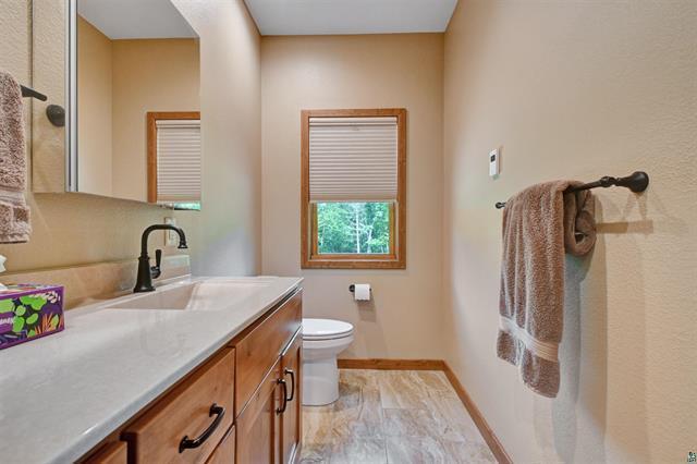 12207 Railroad Rd, Lake Nebagamon, WI 54849 - bathroom with vanity and marble look tiles