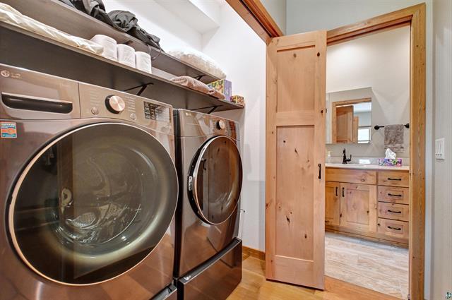 12207 Railroad Rd, Lake Nebagamon, WI 54849 - laundry room with light wood-type flooring and washer and dryer