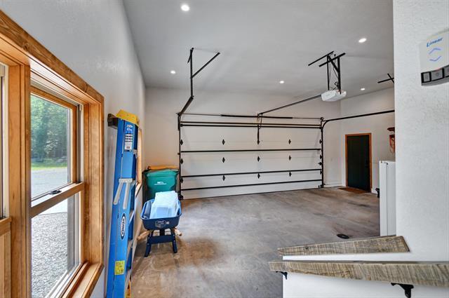 12207 Railroad Rd, Lake Nebagamon, WI 54849 - garage featuring a garage door opener and recessed lighting