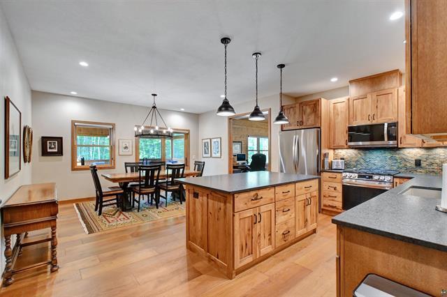 12207 Railroad Rd, Lake Nebagamon, WI 54849 - kitchen featuring appliances with stainless steel finishes, dark countertops, light wood-style floors, pendant lighting, and recessed lighting