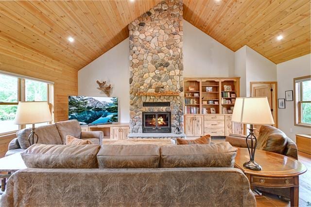 12207 Railroad Rd, Lake Nebagamon, WI 54849 - living area with high vaulted ceiling, a stone fireplace, wood ceiling, and recessed lighting