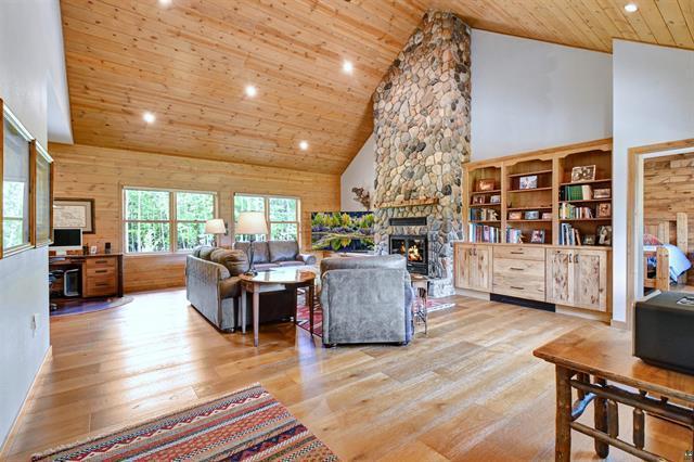 12207 Railroad Rd, Lake Nebagamon, WI 54849 - living room with a fireplace, wood finished floors, wooden ceiling, high vaulted ceiling, and recessed lighting
