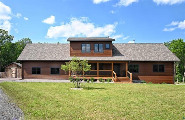 12207 Railroad Rd, Lake Nebagamon, WI 54849 - view of front of property featuring a porch, a front yard, and a storage unit