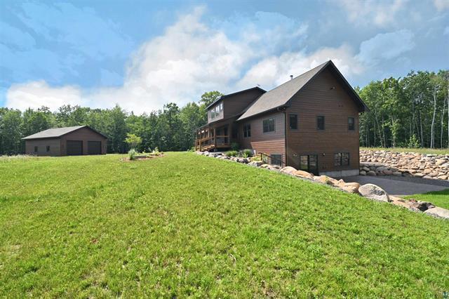 12207 Railroad Rd, Lake Nebagamon, WI 54849 - view of property exterior featuring a yard and a detached garage