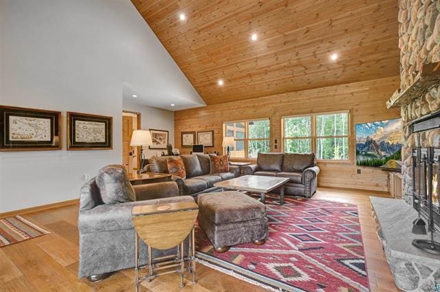 12207 Railroad Rd, Lake Nebagamon, WI 54849 - living room with recessed lighting, high vaulted ceiling, a stone fireplace, wood finished floors, and wooden ceiling