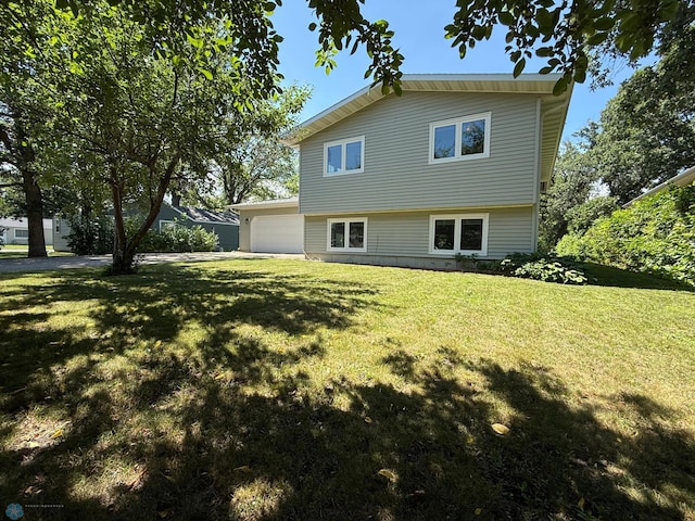 1303 Duluth Ave N, Thief River Falls, MN 56701 - view of property exterior with a garage, a yard, and driveway