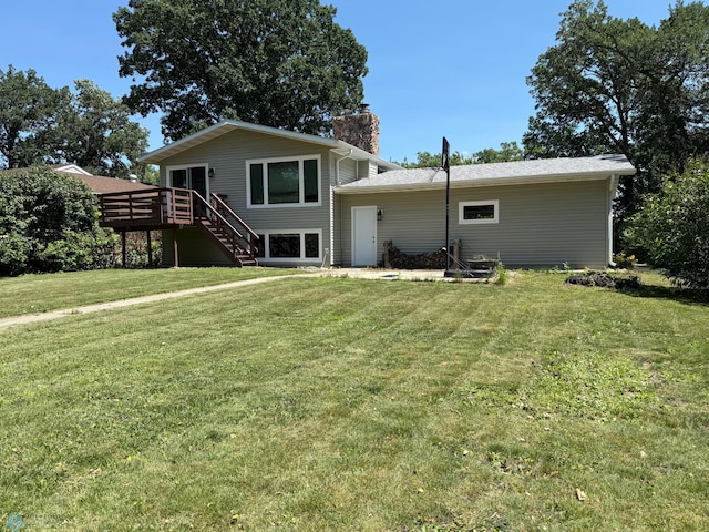 1303 Duluth Ave N, Thief River Falls, MN 56701 - rear view of property featuring a chimney, a deck, stairs, and a yard