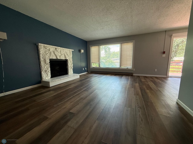 1303 Duluth Ave N, Thief River Falls, MN 56701 - unfurnished living room with a textured ceiling, dark wood-style flooring, a fireplace, and a baseboard heating unit