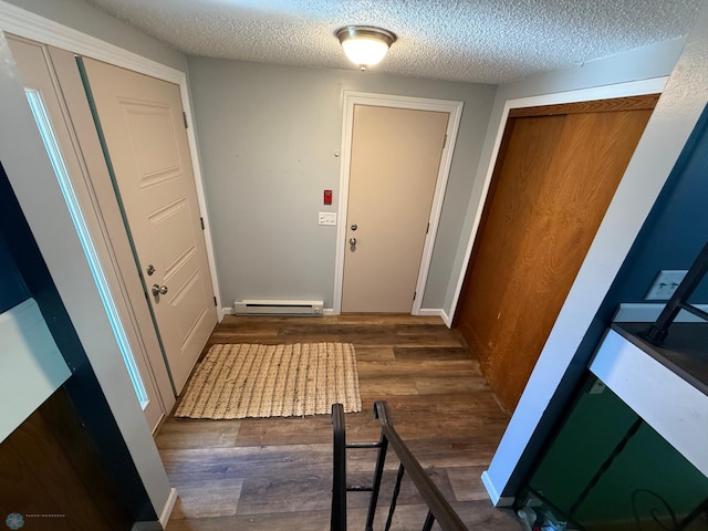 1303 Duluth Ave N, Thief River Falls, MN 56701 - doorway featuring wood finished floors, a textured ceiling, and baseboard heating