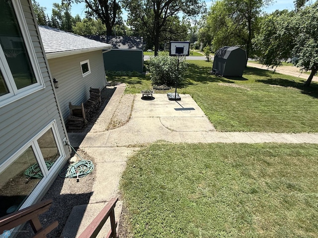 1303 Duluth Ave N, Thief River Falls, MN 56701 - view of green lawn featuring a patio and an outdoor fire pit
