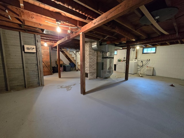 818 Kenwood St, Alexandria, MN 56308 - below grade area featuring stairs, heating unit, and washer and dryer