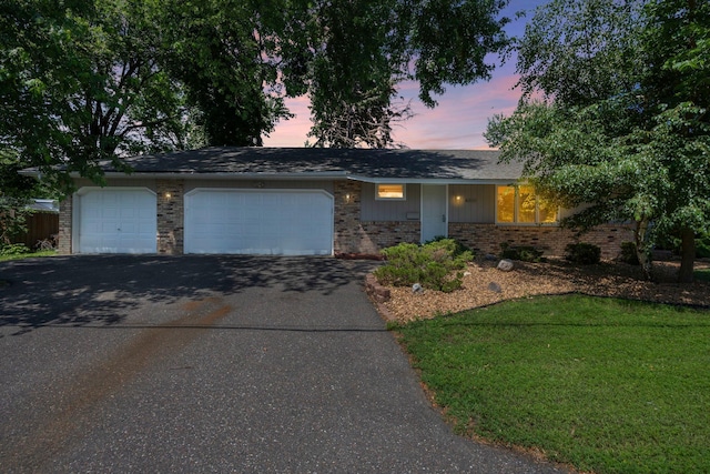 4801 Louisiana Ave N, Crystal, MN 55428 - ranch-style home with brick siding, asphalt driveway, a garage, and a yard