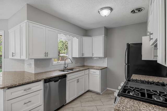 4801 Louisiana Ave N, Crystal, MN 55428 - kitchen with stainless steel dishwasher, gas range, decorative backsplash, stone counters, and white cabinetry