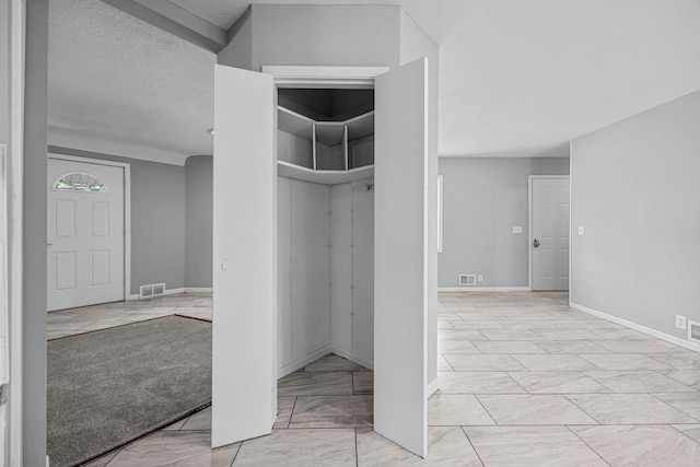 4801 Louisiana Ave N, Crystal, MN 55428 - interior space featuring a textured ceiling and light marble finish floors