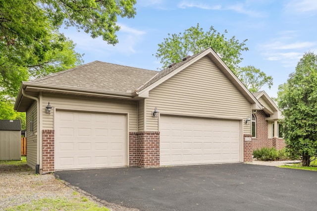 11228 River Rd, Champlin, MN 55316 - ranch-style house with brick siding, driveway, an attached garage, and a shingled roof